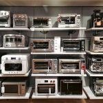 A bunch of microwaves that are on a shelf