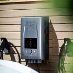 Electric car charger mounted on wooden wall