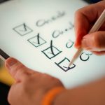 A hand marks off items on a checklist
