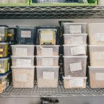 a shelf filled with containers and containers of food