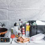a stove top with a plate of food on it