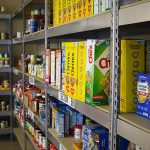 A shelf in a store filled with lots of food